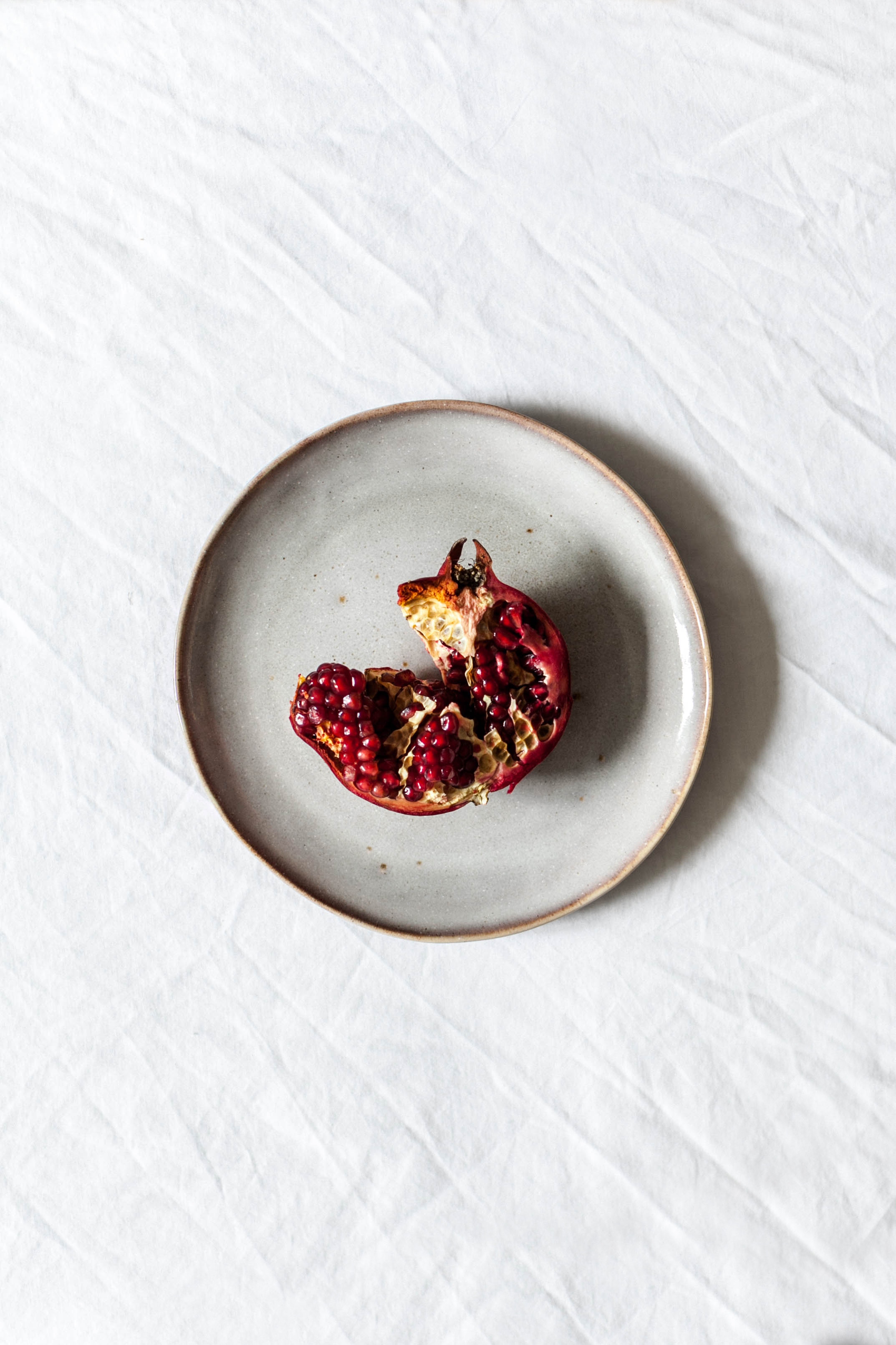 An open pomegranate on a plate